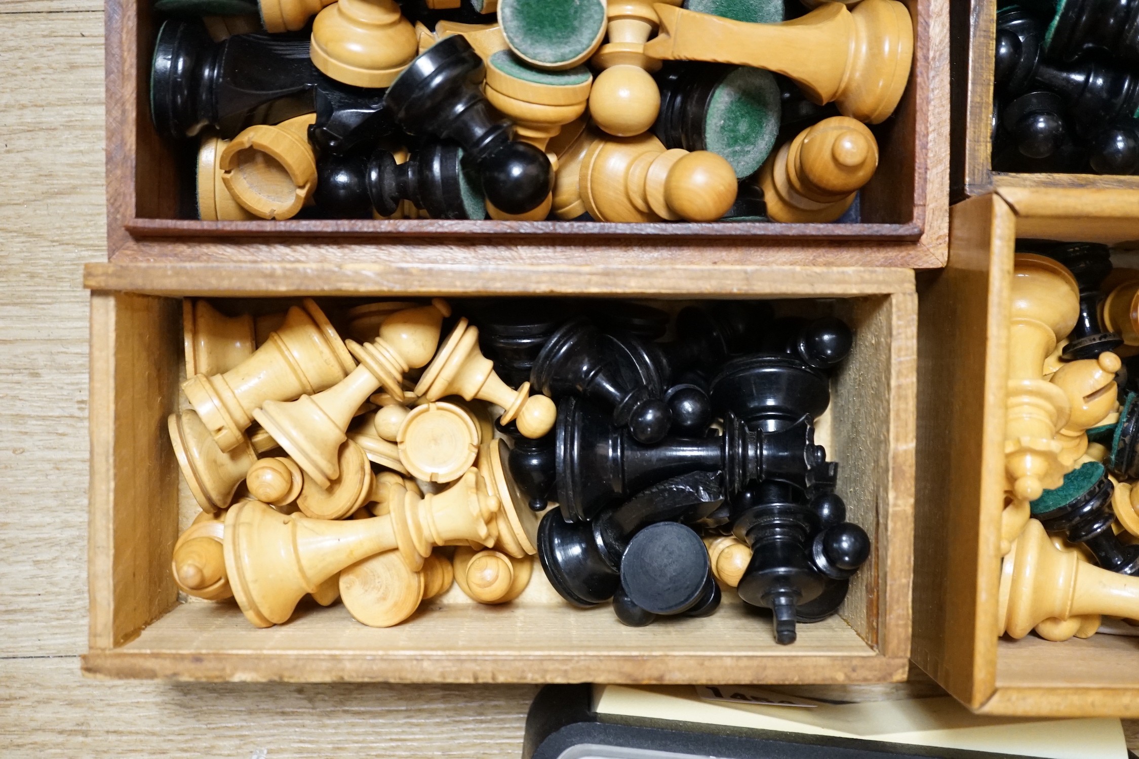 A collection of four wooden chess sets and a clock